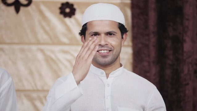 Indian muslim man doing Adab and smiling