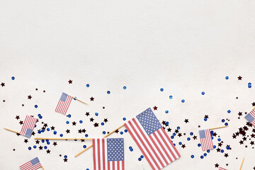 Obraz premium USA flags with stars and sequins on white background. Memorial Day celebration