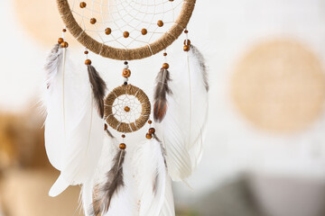 Dream catcher hanging in light room, closeup