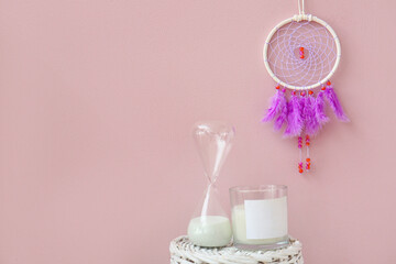 Dream catcher hanging on pink wall