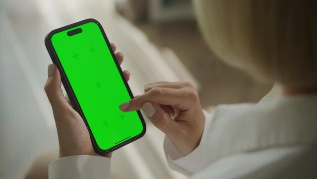 Smartphone with a green screen and hand scrolling
