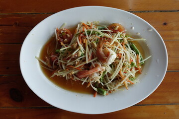 The most popular food in Thailand is Papaya salad is made with grated papaya strips.