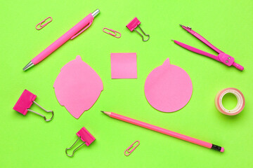 Sticky notes and stationery on green background