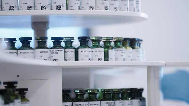 A perfumer combs through the various fragrances in his laboratory