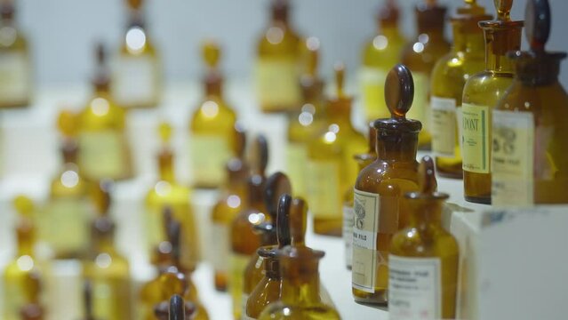 ancient parfum flacons lined up in a museum