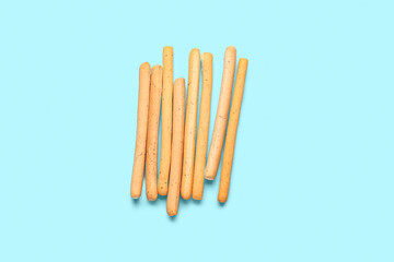 Tasty Italian Grissini on blue background