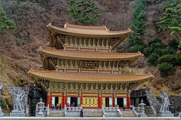 a traditional Korean temple decorated with gold tiles
