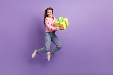 Full length photo of excited funny lady dressed strawberry cardigan jumping holding gift empty...