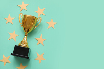 Gold cup with stars on mint background