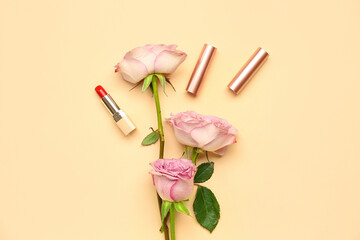 Obraz na płótnie Canvas Lipsticks with roses on beige background