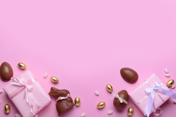 Chocolate bunny, Easter eggs and gift boxes on pink background