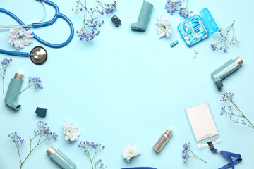 Frame made of asthma inhalers, medical supplies and flowers on blue background - obrazy, fototapety, plakaty