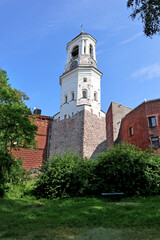 Clock tower in Vyborg, Russia. Cityscape with old stone houses in the historic center.