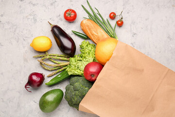 Fototapeta na wymiar Paper bag with vegetables, bread and fruits on background