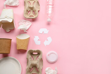 Recycling sign with garbage on pink background