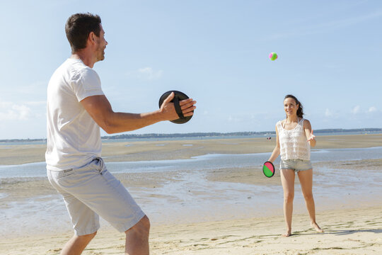 friends playing on the beach - Powered by Adobe