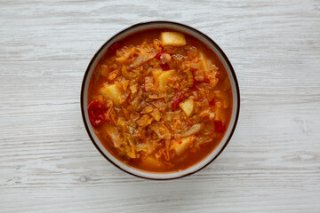 Homemade Shredded Cabbage and Potato Soup in a Bowl, top view. Overhead, from above, flat lay.