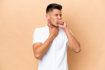 Young caucasian man isolated on beige background coughing a lot