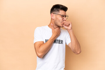 Young volunteer caucasian man isolated on beige background is suffering with cough and feeling bad