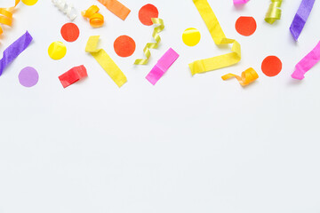 Composition with colorful confetti on white background