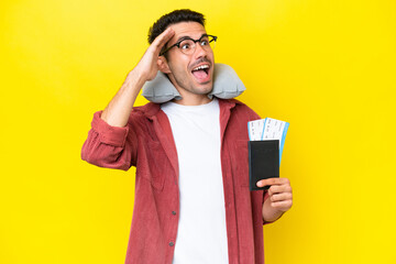 Young handsome man with Inflatable Travel Pillow over isolated yellow background smiling a lot