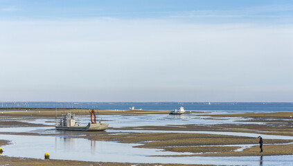 Boats resting on the ocean's bed at low tide at the Cap Ferret along the Atlantic ocean's coastline