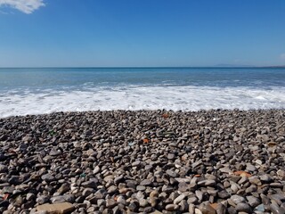 Fototapeta na wymiar Gray wet stones on the seashore
