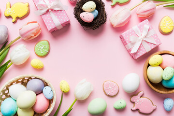 Easter frame with eggs, gift box and tulip on a colored background. The minimal concept. Top view Happy Easter composition. Card with a copy space of the place for the text