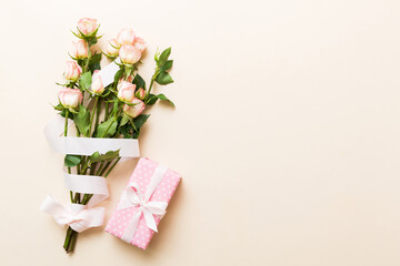 design concept with pink rose flower and gift box on colored table background top view. Happy Holiday, Mothers day, birthday concept. Romantic flat lay composition