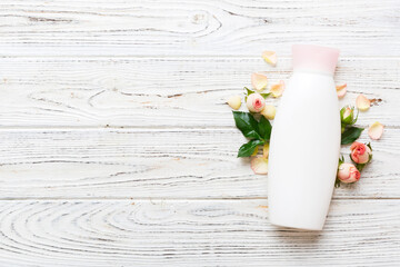 Fancy healthcare bottles for cream with rose flower. Natural oranic spa cosmetics concept. Mockup, template, Top view