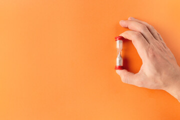 Hourglass in hand. Copy space.