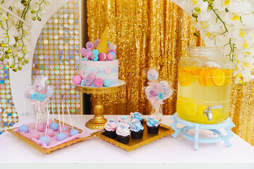 candy bar with lemonade, desserts and multicolored cake.