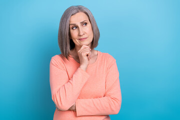 Photo of intelligent grandmother white gray hair dressed pink pullover hand on chin look empty...