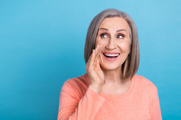 Photo of excited funny woman wear coral shirt arm lips looking empty space isolated blue color...