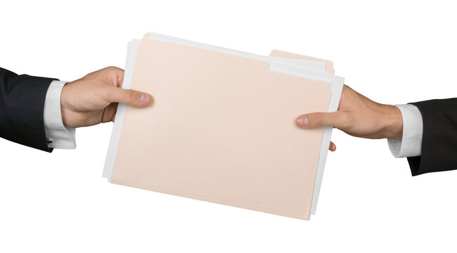 Closeup of Businesspeople Handing File Folder