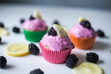 Closeup of purple cupcakes with blackberries