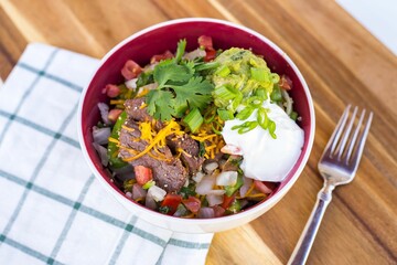 High angle closeup of a fresh salad with sour cream