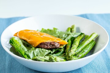 Closeup of a Hamburger without bread and asparagus