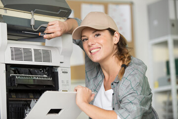 woman servicing a photocopier