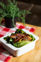 High angle closeup of a lettuce wrap in a small dish