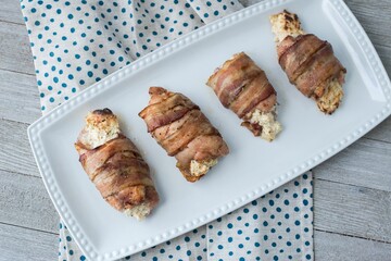Top view of a plate with chicken wrapped with bacon