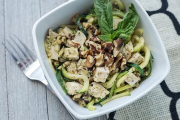 High angle closeup of a zucchini and chicken pasta dish