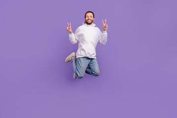 Full body photo of youngster eco friendly model hispanic man jump hoodie adidas made recycled materials isolated on purple color background