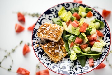 Closeup shot of a healthy breakfast with meat and a fresh vegetable salad put on the table
