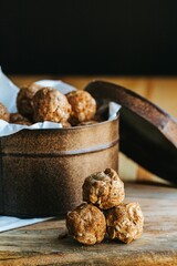 Vertical closeup shot of the oatmeal cookie bites with the background of a box full of cookie bites