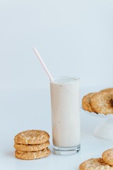 Vertical of the fresh milkshake with cookies isolated on the empty white background