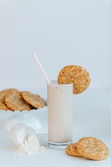 Vertical of the fresh milkshake with cookies isolated on the empty white background