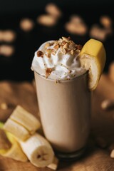 Vertical shot of a banana shake on the brown background