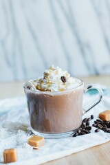 Vertical shot of a caramel hot chocolate on the white background