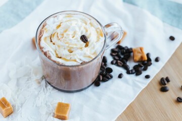 High angle of a fresh and sweet hot chocolate with cream put on the table